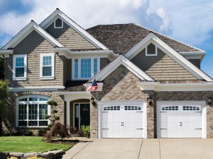 Two carriage-style garage doors for an attached garage on a two-story suburban home